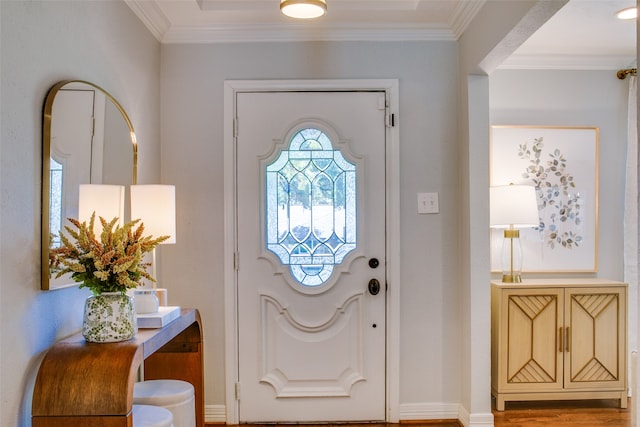 entryway with ornamental molding and wood-type flooring