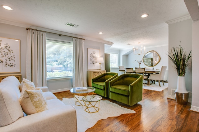 living room featuring dark wood-type flooring, a wealth of natural light, and ornamental molding