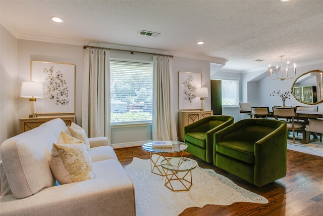 living room with plenty of natural light, ornamental molding, an inviting chandelier, and dark wood-type flooring