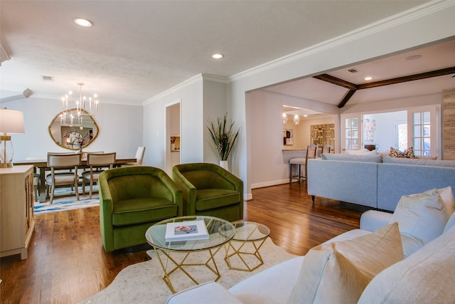 living room featuring ornamental molding, dark hardwood / wood-style floors, and an inviting chandelier