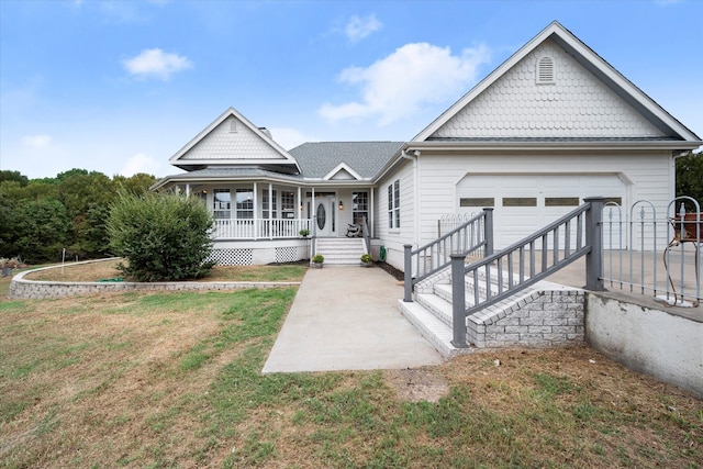 view of front of property with covered porch, a front yard, and a garage