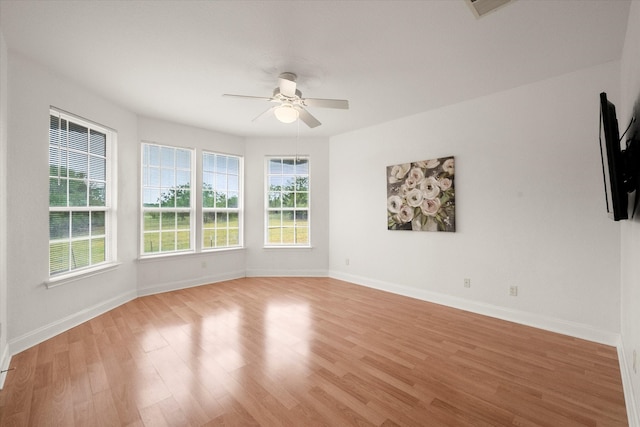 unfurnished room featuring plenty of natural light, light hardwood / wood-style flooring, and ceiling fan