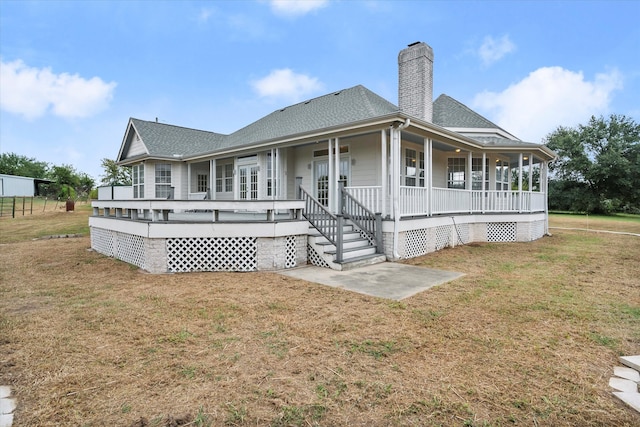 rear view of property with a porch and a lawn