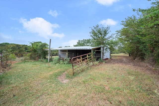 view of yard with a rural view and an outdoor structure