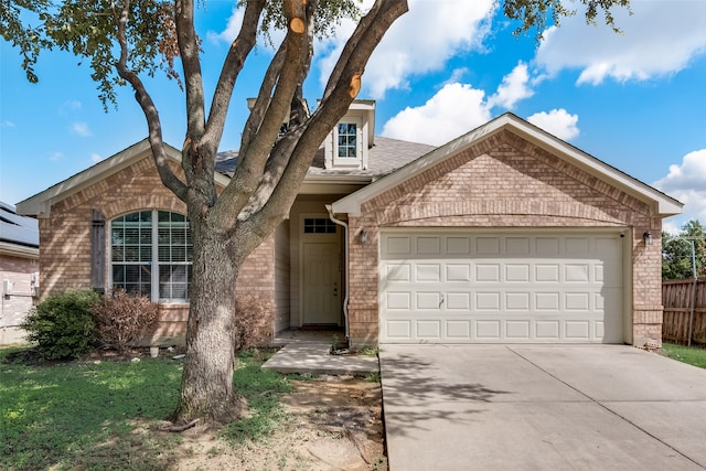 view of front of home featuring a front yard and a garage