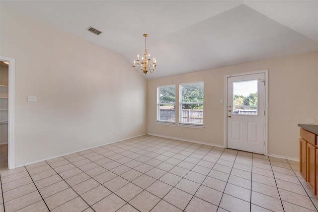 spare room featuring vaulted ceiling, an inviting chandelier, and light tile patterned floors