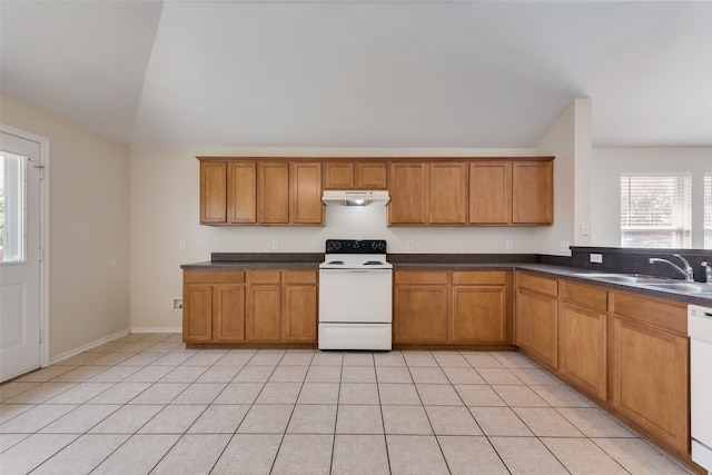 kitchen with vaulted ceiling, sink, light tile patterned floors, and white appliances