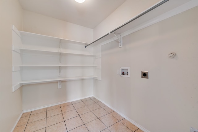 laundry room featuring washer hookup, light tile patterned flooring, and hookup for an electric dryer