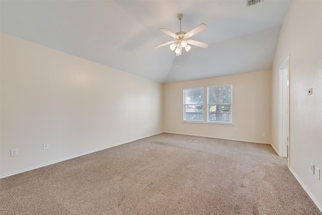 unfurnished room with light colored carpet, ceiling fan, and vaulted ceiling