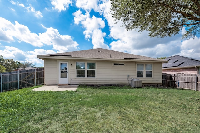 rear view of house featuring a lawn, a patio, and central AC