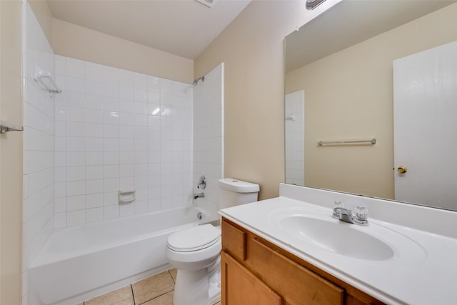 full bathroom with tile patterned flooring, toilet, tiled shower / bath combo, and vanity