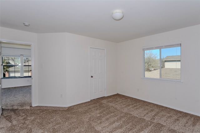 carpeted spare room with a healthy amount of sunlight