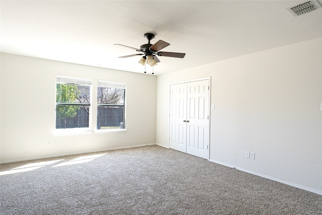 unfurnished room featuring ceiling fan and carpet floors