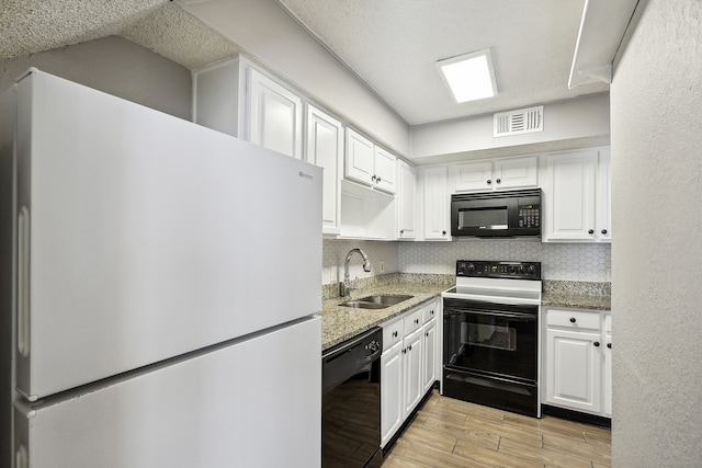 kitchen featuring black appliances, sink, light hardwood / wood-style flooring, and white cabinets