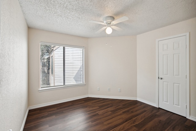 unfurnished room with dark wood-type flooring, a textured ceiling, and ceiling fan