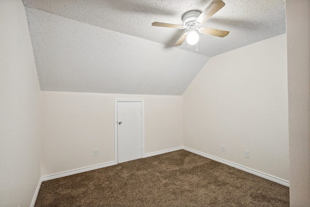 bonus room featuring lofted ceiling, ceiling fan, carpet floors, and a textured ceiling