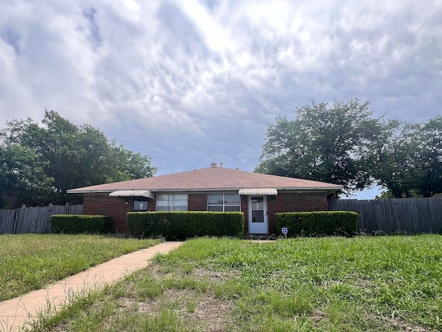 ranch-style house with a front lawn