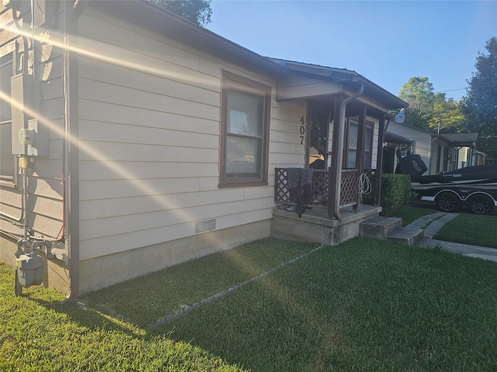 view of property exterior with a yard