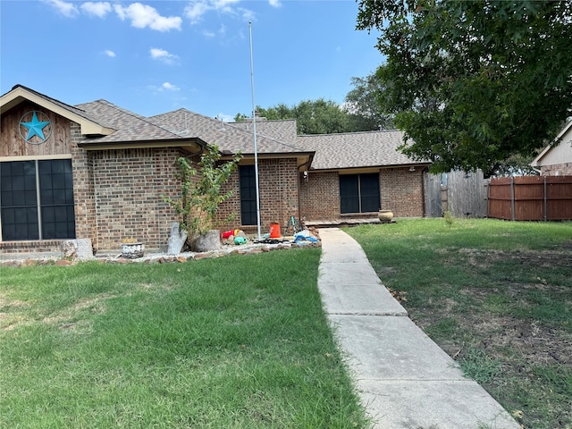 ranch-style home featuring a front yard