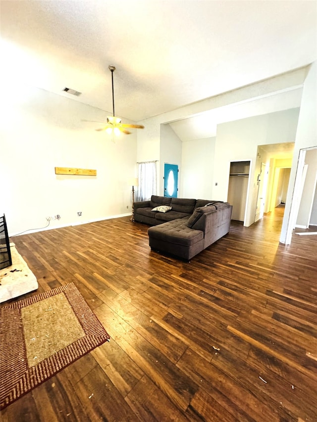 living room with dark wood-type flooring, vaulted ceiling, and ceiling fan