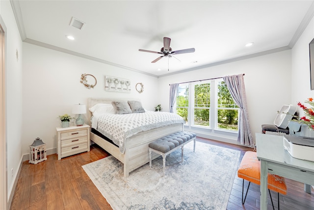 bedroom with ceiling fan, crown molding, and hardwood / wood-style floors