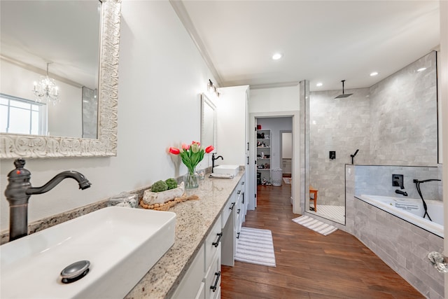 bathroom with ornamental molding, wood-type flooring, vanity, a chandelier, and plus walk in shower