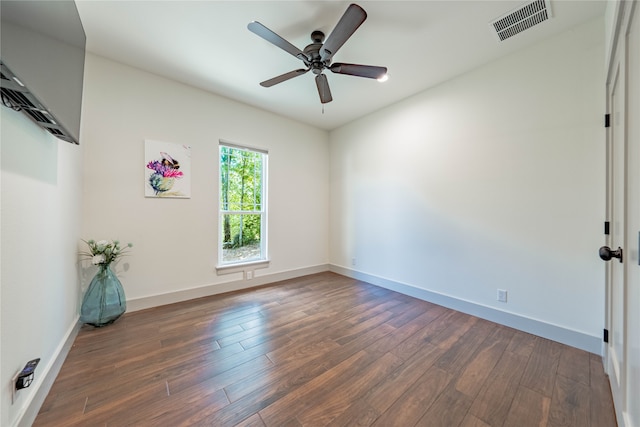 spare room featuring ceiling fan and dark hardwood / wood-style floors