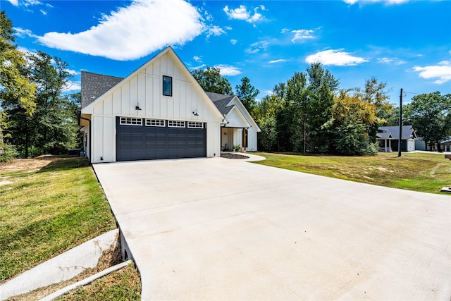 modern farmhouse style home featuring a garage and a front lawn