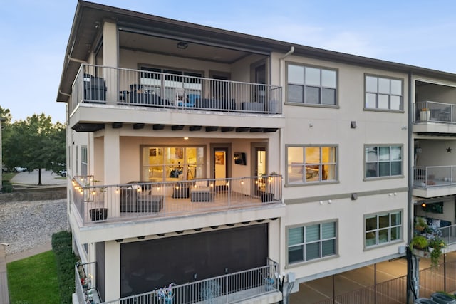 rear view of property featuring a balcony