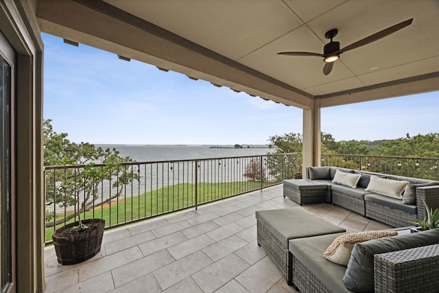 view of patio with a balcony, a water view, ceiling fan, and outdoor lounge area