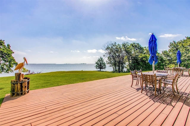 wooden terrace with a lawn and a water view