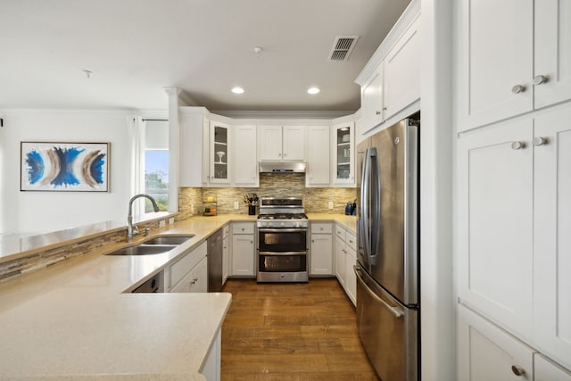 kitchen featuring stainless steel appliances, white cabinets, dark hardwood / wood-style floors, and sink