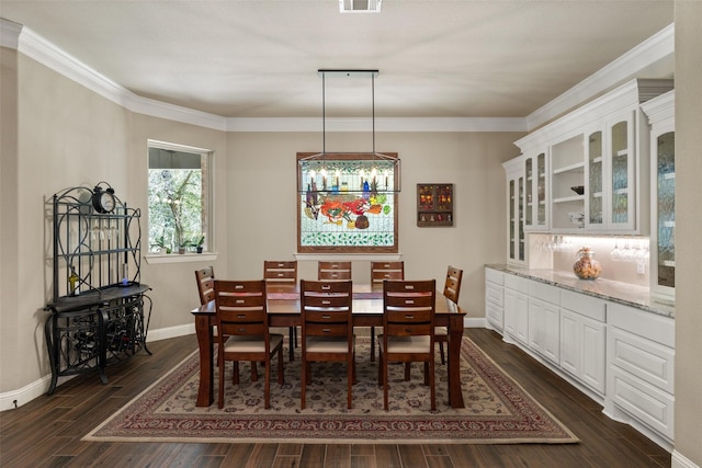 dining room with dark wood-style floors, baseboards, visible vents, and ornamental molding