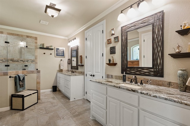 full bathroom featuring baseboards, ornamental molding, a sink, a walk in shower, and two vanities