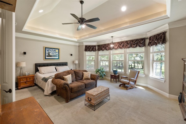 bedroom with baseboards, light colored carpet, ornamental molding, a tray ceiling, and recessed lighting