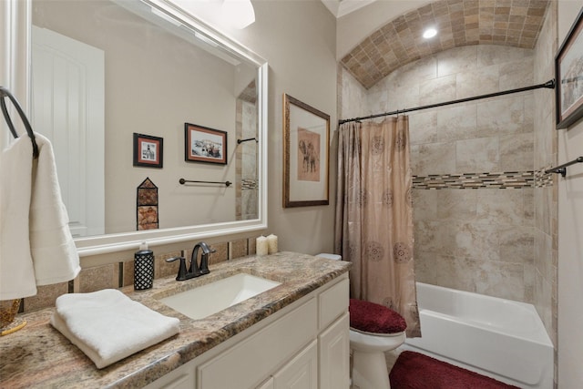 full bath featuring lofted ceiling, vanity, shower / bath combo with shower curtain, and toilet