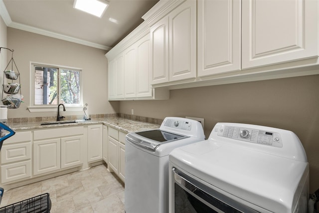 laundry room with crown molding, cabinet space, a sink, and separate washer and dryer