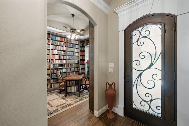 foyer entrance with crown molding, ceiling fan, and dark hardwood / wood-style flooring