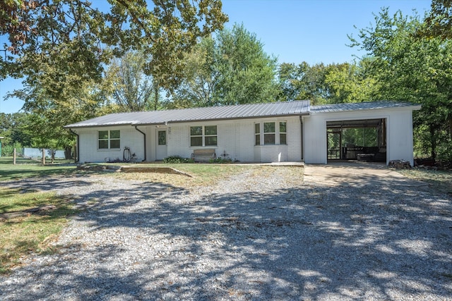 ranch-style home featuring a carport