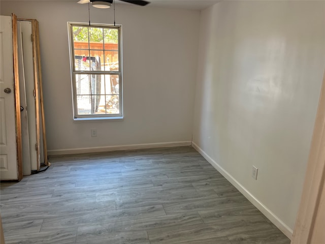 empty room featuring ceiling fan and light wood-type flooring