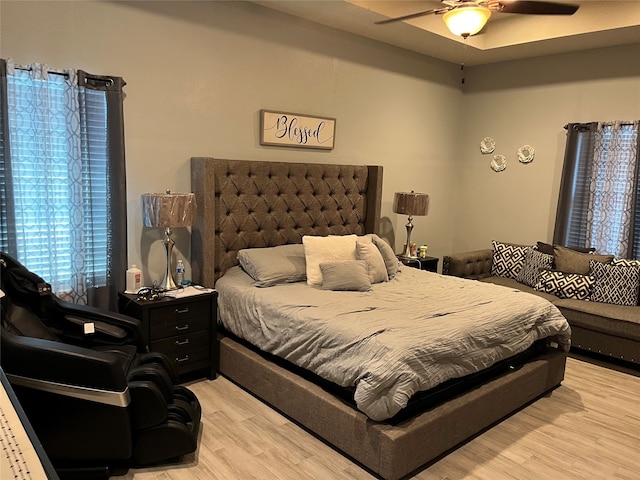 bedroom with ceiling fan and light hardwood / wood-style floors