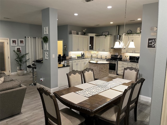 dining room featuring a notable chandelier and light hardwood / wood-style flooring