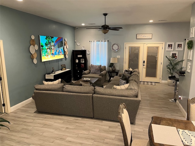 living room featuring ceiling fan and light hardwood / wood-style floors