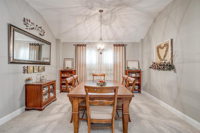 carpeted dining area with vaulted ceiling and a notable chandelier