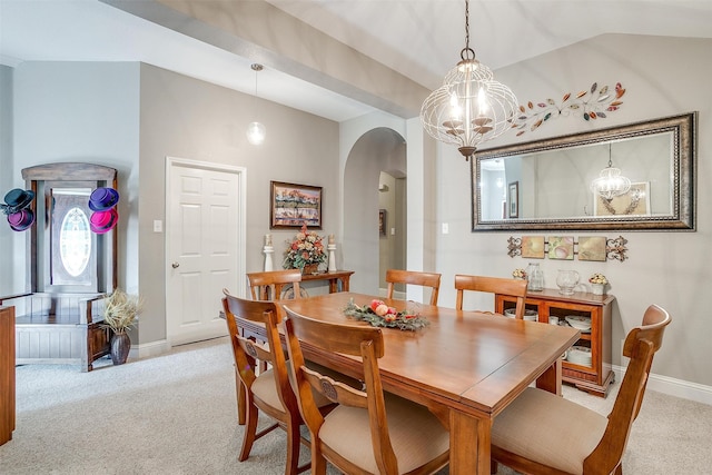 dining space featuring lofted ceiling and light colored carpet