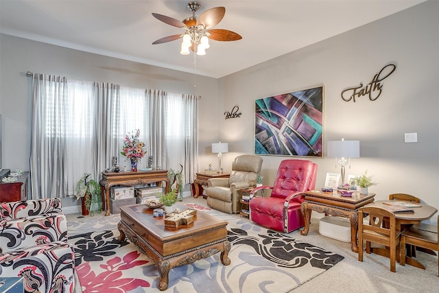 living room with carpet, ceiling fan, and a fireplace