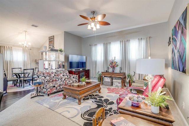 living room with lofted ceiling, ceiling fan with notable chandelier, and hardwood / wood-style flooring