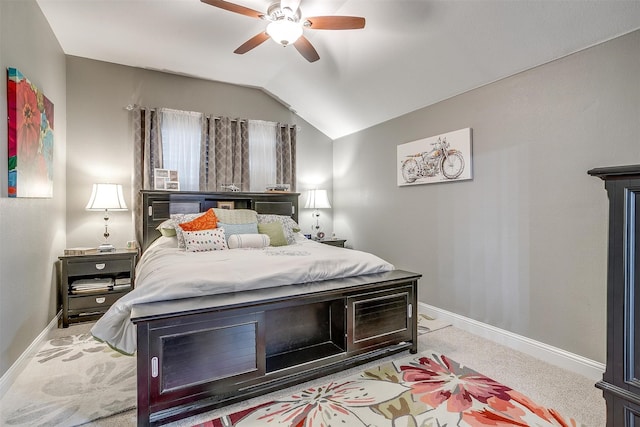 bedroom with lofted ceiling, ceiling fan, and light colored carpet