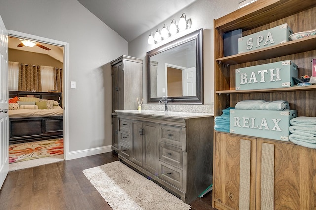 bathroom featuring vanity, ceiling fan, wood-type flooring, and vaulted ceiling