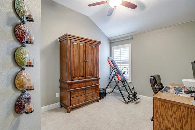 carpeted home office with lofted ceiling and ceiling fan